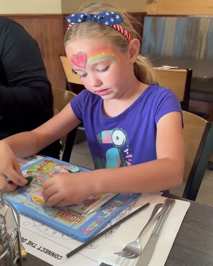 Children using Beansie to draw, play, and explore activity sheets