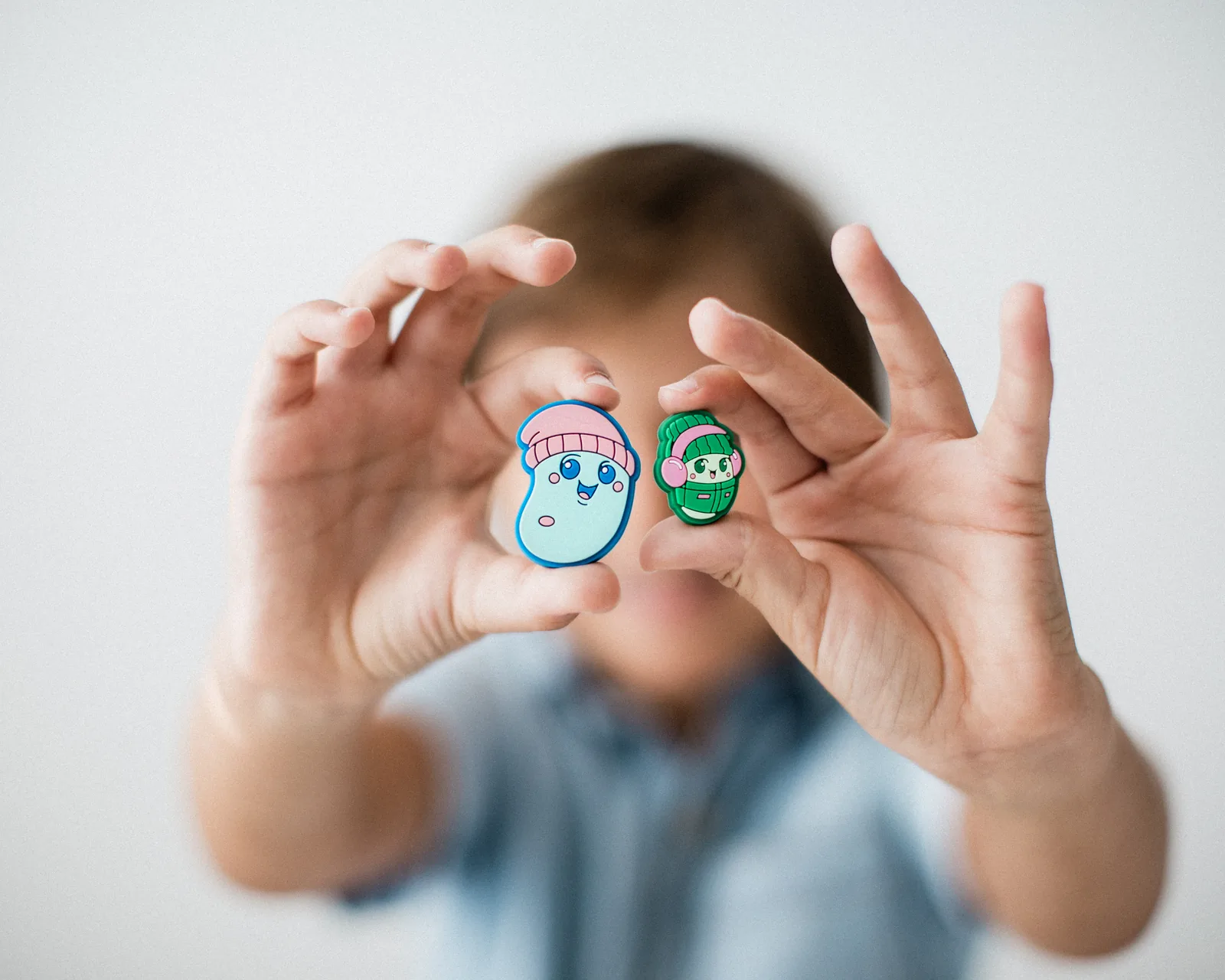 Child holding magnetic Beansie characters for imaginative play